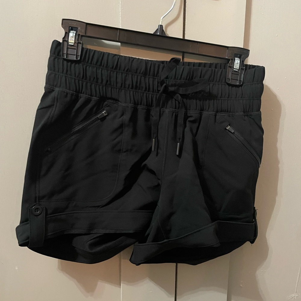 Black athletic shorts with cuffed bottom and pockets